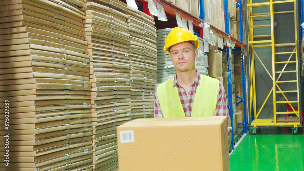 Multi ethnic workers in yellow helmet, reflective jacket in warehouse Multi ethnic workers in yellow helmet, reflective jacket in warehouse