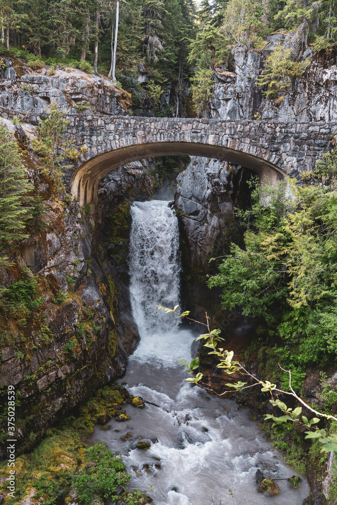 Christine Falls in Mt Rainier National Park is a waterfall with a picturesque bridge Christine Falls in Mt Rainier National Park is a waterfall with a picturesque bridge