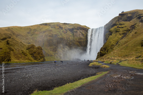 Tourists visiting Skógafoss waterfall in Iceland