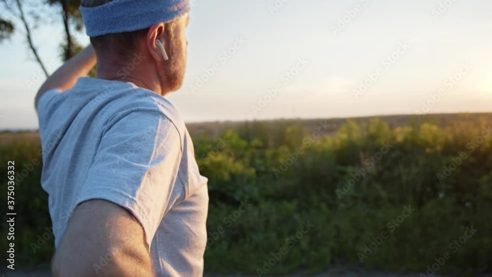 Caucasian senior man doing yoga exercises in front of amazing sunset. Bearded elderly sportsman feeling well and full of life energy while training at summer wild nature. Healthy active lifestyle. 4K Caucasian senior man doing yoga exercises in front of amazing sunset. Bearded elderly sportsman feeling well and full of life energy while training at summer wild nature. Healthy active lifestyle. 4K