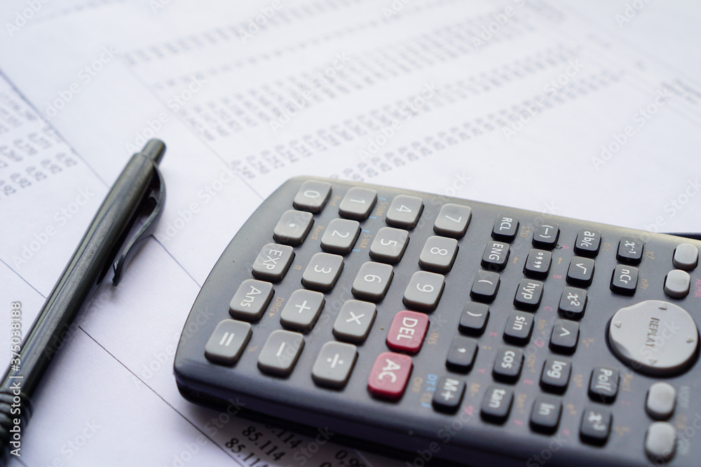 Calculator and numbers sheet paper. data and earning analysis concept Calculator and numbers sheet paper. data and earning analysis concept