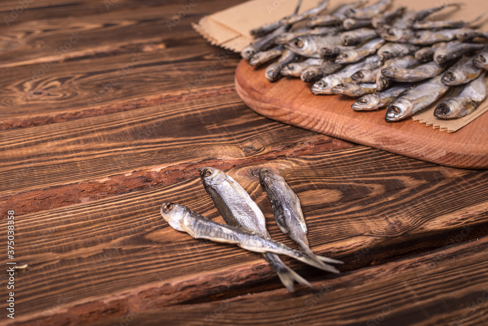 Dried fish on a wooden background. Studio photo.