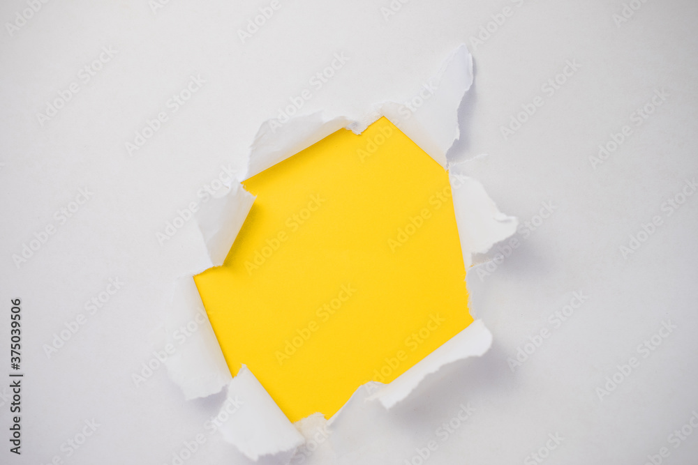 Φωτογραφία The abstract is full of holes with a white paper on yellow background for concept design with space for your text