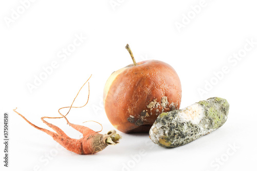  rotten apple, cucumber, carrot on white background photo