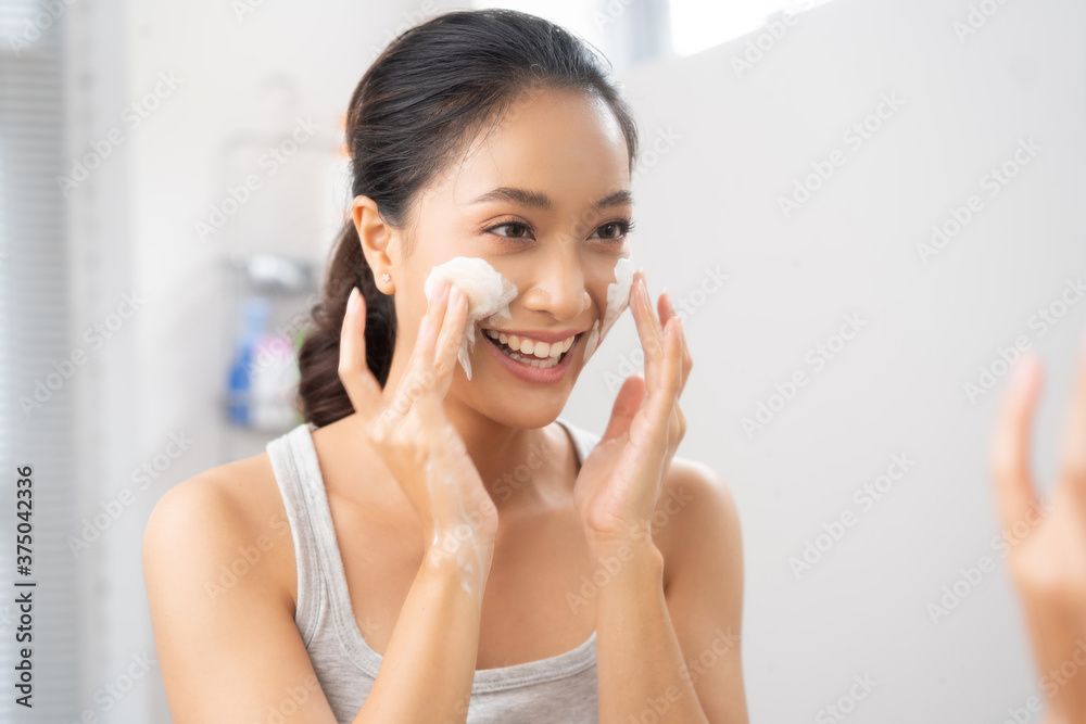 Beautiful female asian Wash face  in bathroom