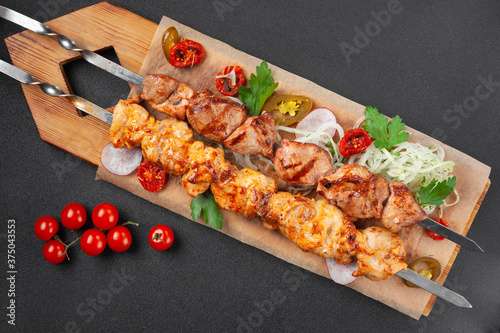 Hot grilled chicken shish kebab, with cherry tomatoes,