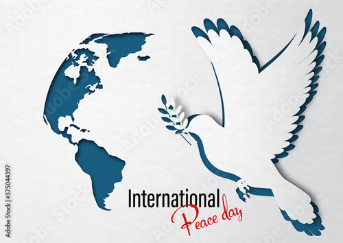 Closeup a dove peace with world map in paper cut style and "International Peace Day" lettering on white paper pattern and dark blue background.
