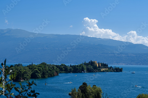 Island Garda, Lake Garda, Italy. Is the biggest island on Lake Garda. In the background Alps, blue sky.