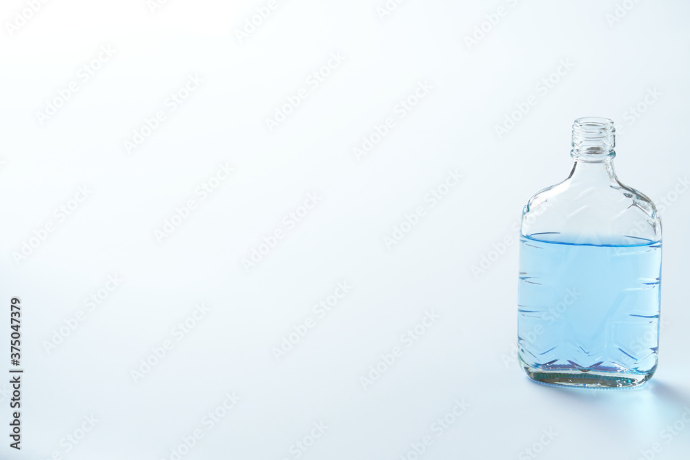 青い色水を入れた透明な空き瓶 Stock Photo Adobe Stock