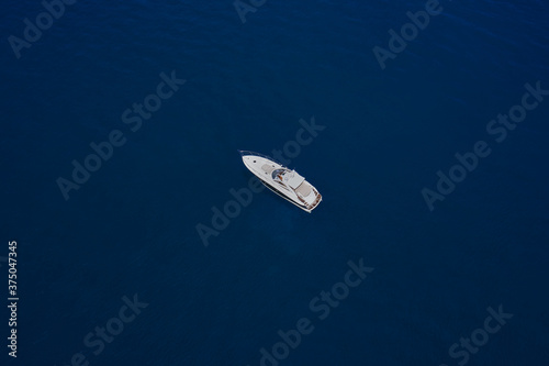 Yacht on blue water. Top view of the boat.