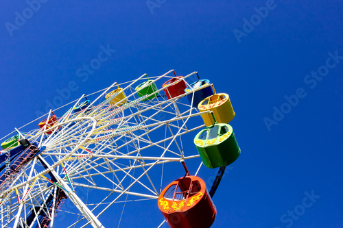 Photography A ferris wheel with colorful cabins