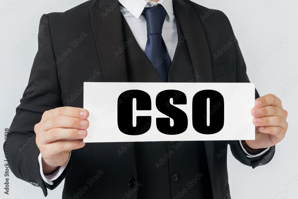 A businessman holds a sign in his hands which says CSO -CHIEF STRATEGY OFFICER A businessman holds a sign in his hands which says CSO -CHIEF STRATEGY OFFICER