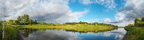 Fototapeta Naklejka Na Ścianę i Meble -  Summer panoramic landscape with calm river and beautiful clouds in blue sky