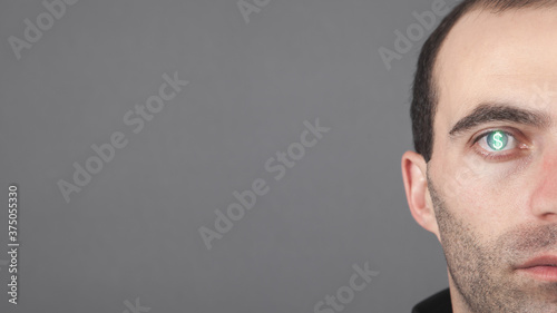 Fotografie Caucasian man with a dollar symbol in his eye