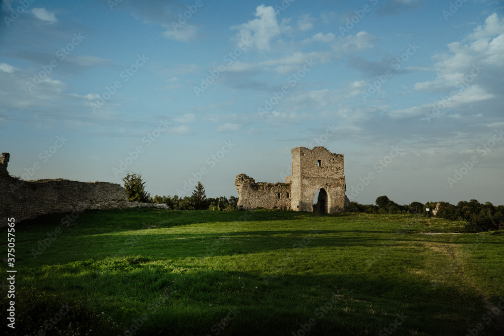 Castle ruins at sunset green grass