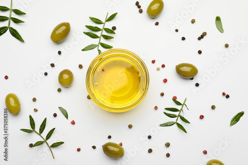 Composition with bowl of olive oil on white background