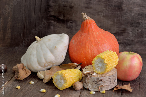 various and colorful autumnal vegetables and fruits on wooden background