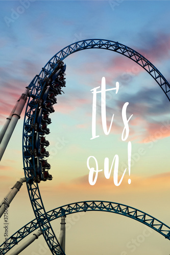Opened amusement park after Covid (coronavirus) outbreak. Silhouette of people having fun on a roller-coaster in an amusement park at sunset. Adrenalin concept. photo