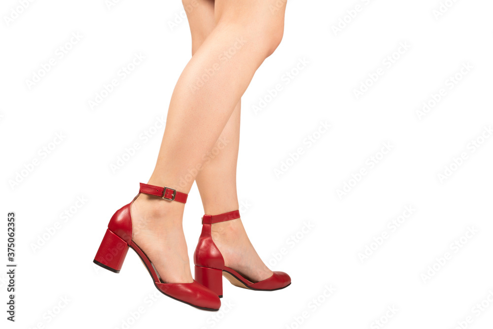 Woman legs in retro red sandals on heels.