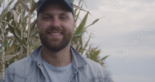 Obraz na plátně Cheerful farmer in corn field