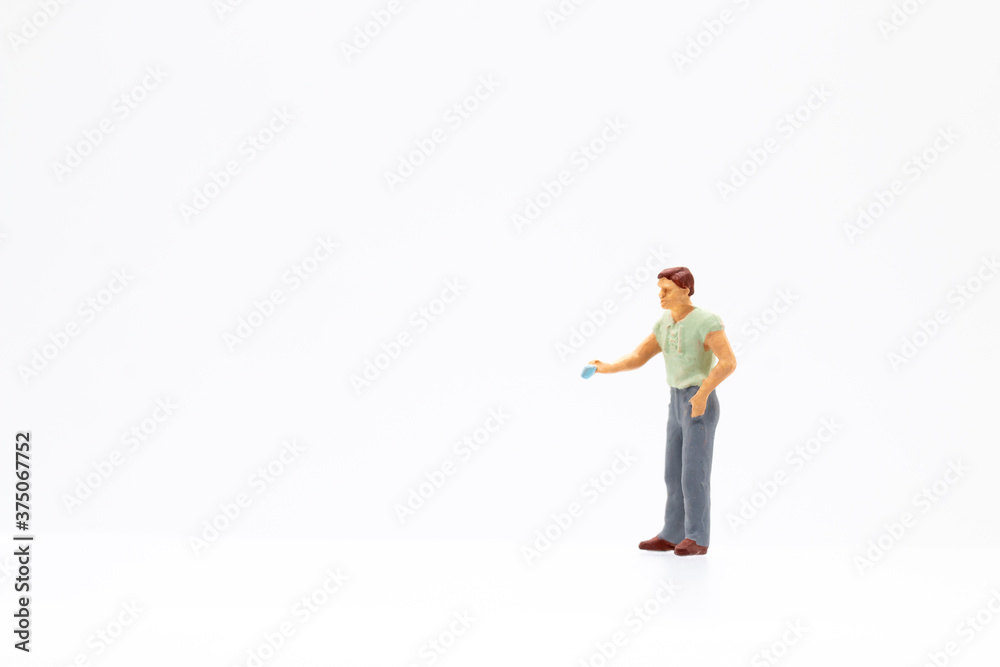 Miniature people standing on white background and copy space for your text Miniature people standing on white background and copy space for your text