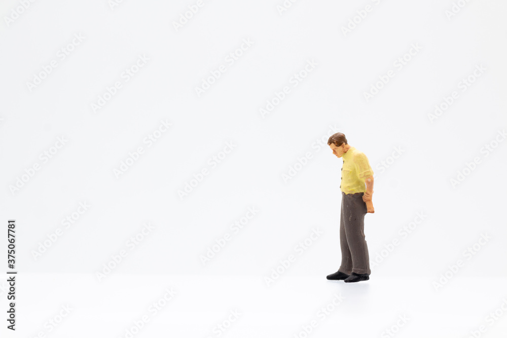 Miniature people standing on white background and copy space for your text Miniature people standing on white background and copy space for your text