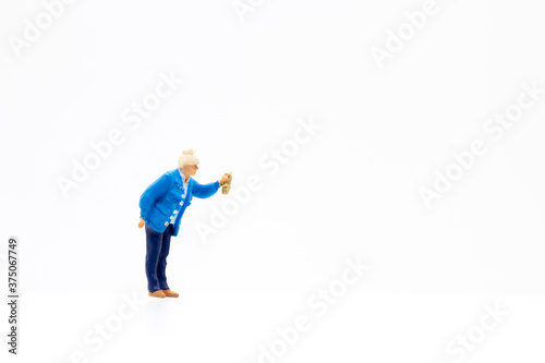 Miniature people standing on white background and copy space for your text 