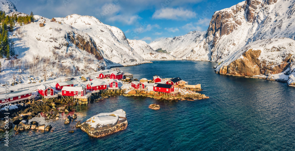 Panoramic winter view of Nusfjord town, Norway, Europe. Exotic morning scene of Lofoten Islands. Impressive seascape of Norwegian sea. View from flying drone. Life over polar circle..