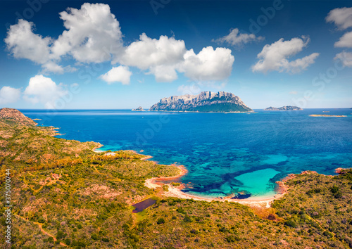 View from flying droneof Spiaggia Del Dottore beach. Aerial morning scene of Sardinia island, Italy, Europe. Spring Mediterranean seascape with Tavolara island on background.