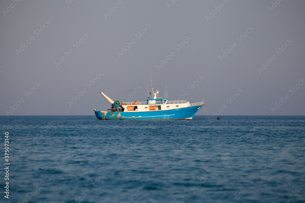 Fishing boat moored offshore (no people around)