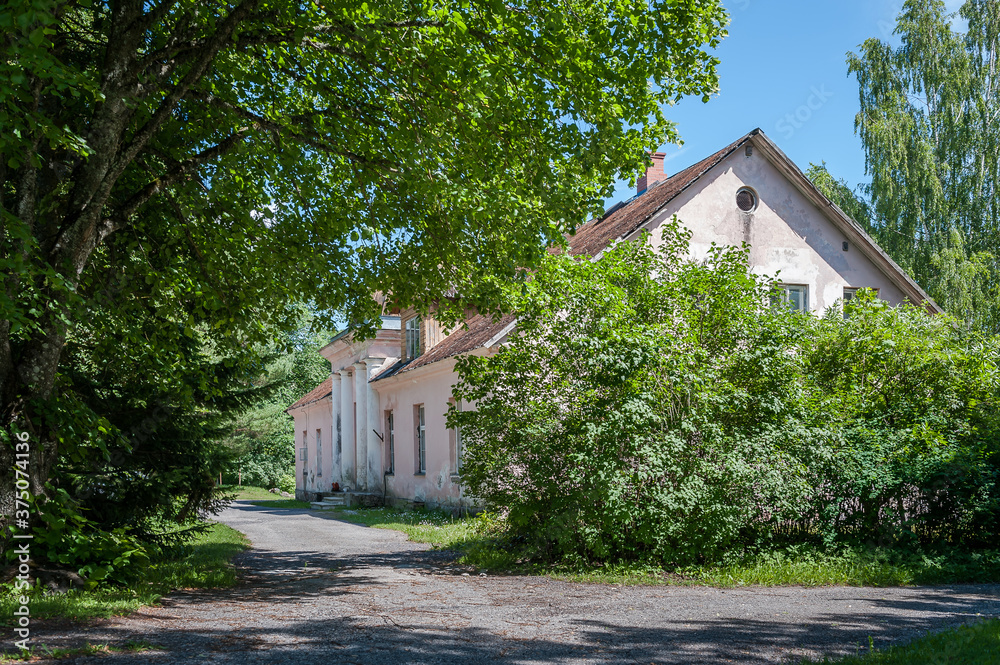 House exterior. Old abandoned house with overgrown yard in an summer season. Estonia. House exterior. Old abandoned house with overgrown yard in an summer season. Estonia.