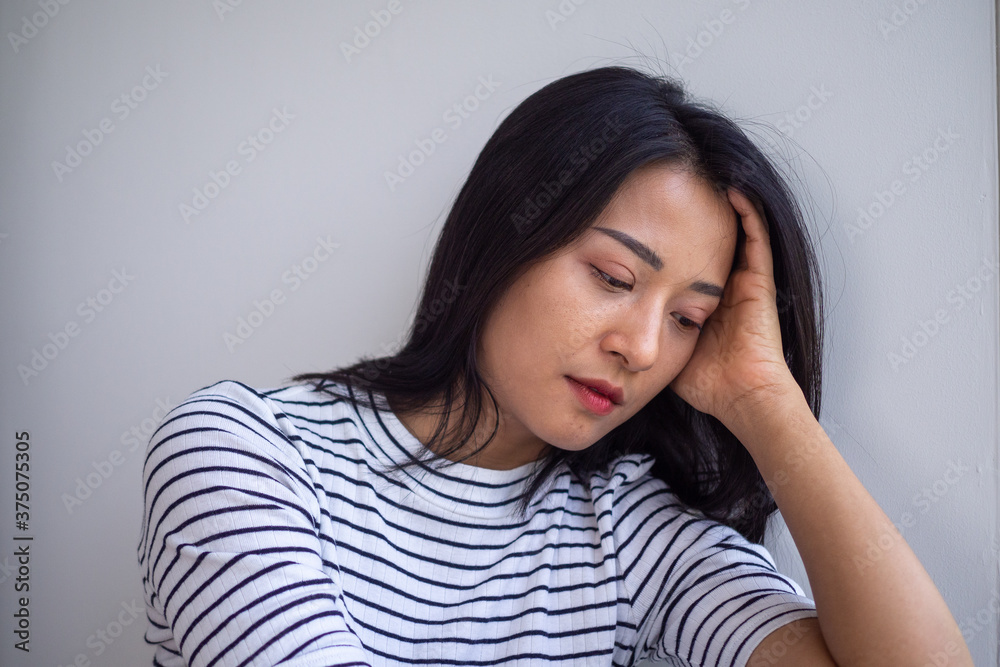 Young Asian women are sad and disappointed. Women have symptoms of depression. Sad and lonely concept Young Asian women are sad and disappointed. Women have symptoms of depression. Sad and lonely concept