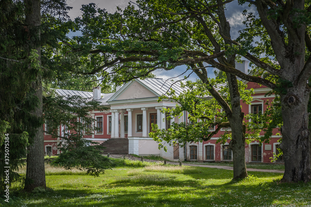 View from the park to the main building of the old manor (Õisu Manor) in summer. Estonia. Baltic. View from the park to the main building of the old manor (Õisu Manor) in summer. Estonia. Baltic.