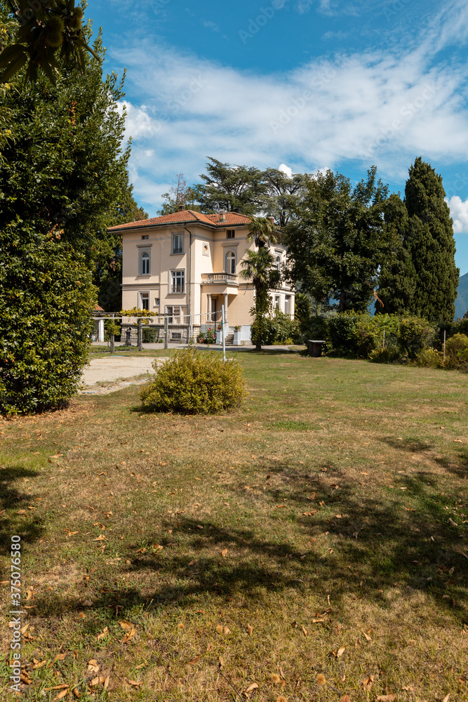 Ancient villa surrounded by nature in the hills in Switzerland. Sunny summer day