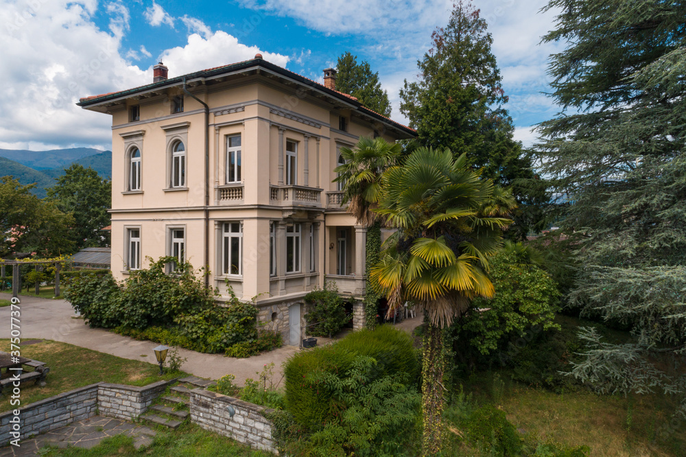 Ancient villa surrounded by nature in the hills in Switzerland. Sunny summer day