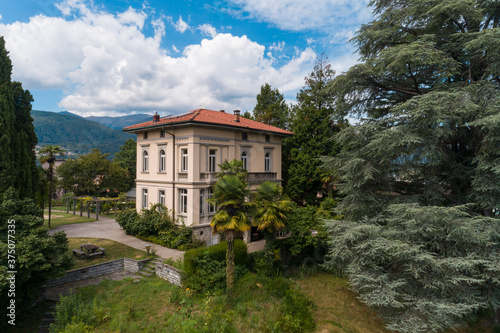 Ancient villa surrounded by nature in the hills in Switzerland. Sunny summer day