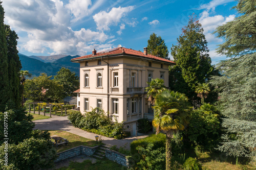 Ancient villa surrounded by nature in the hills in Switzerland. Sunny summer day photo