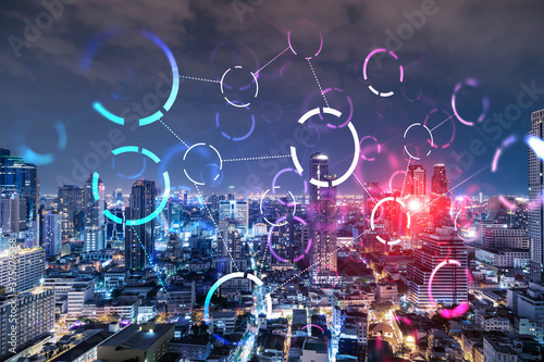 Abstract technology icons  night aerial panoramic cityscape of Bangkok  Asia. The concept of innovative approach to optimize international business process. Double exposure.