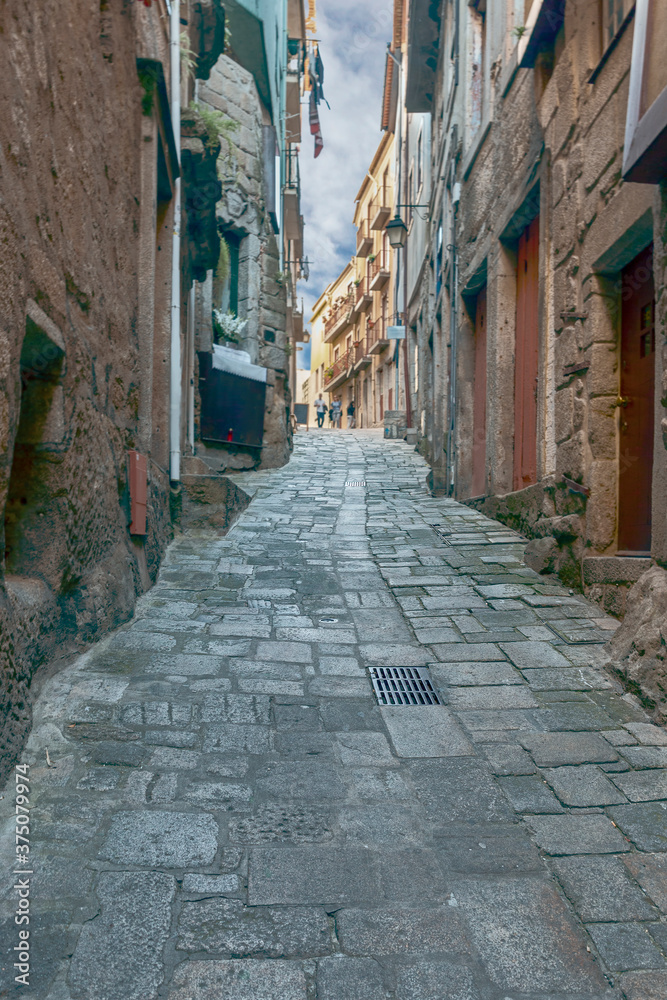 a narrow cobbled street that rises steeply in the historic part of the Portuguese capital