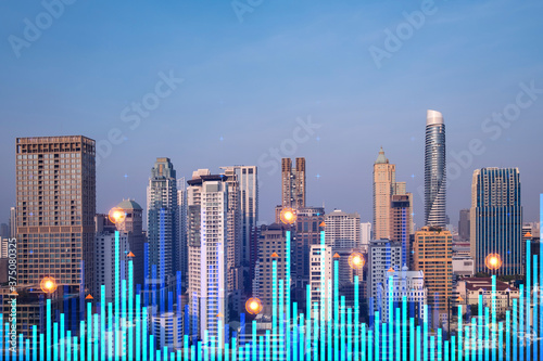 Market behavior graph hologram, sunset panoramic city view of Bangkok, popular location to achieve financial degree in Asia. The concept of financial data analysis. Double exposure. © VideoFlow