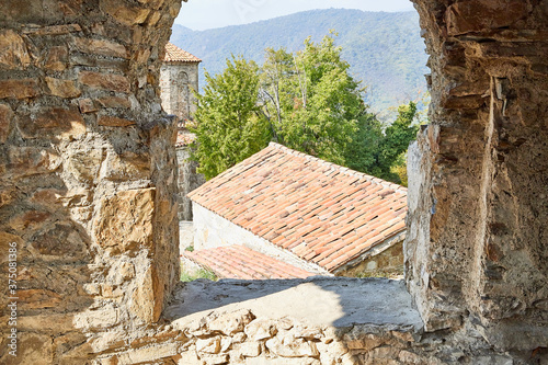 Roof of Old house with yellow stones and bricks in the mountains. Orthodox church in Nekresi Monastery located in Georgia. photo