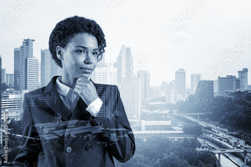 Photography Attractive black African American business woman in suit with hand on chin thinking how to succeed, new career opportunities, MBA