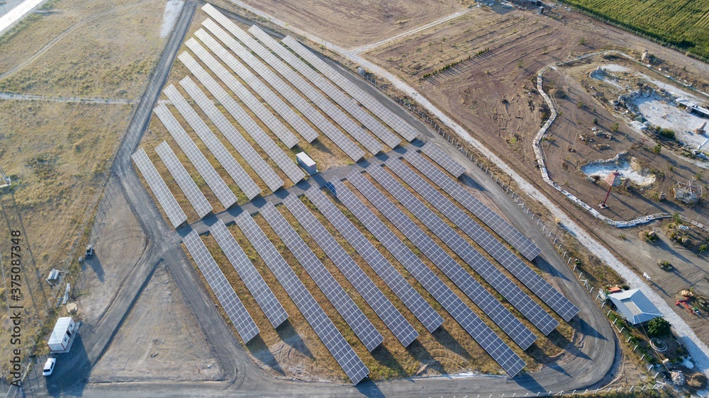 Aerial view of the solar panel system. agricultural fields can be seen.	
