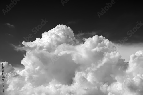White clouds in the sky, black and white photo.