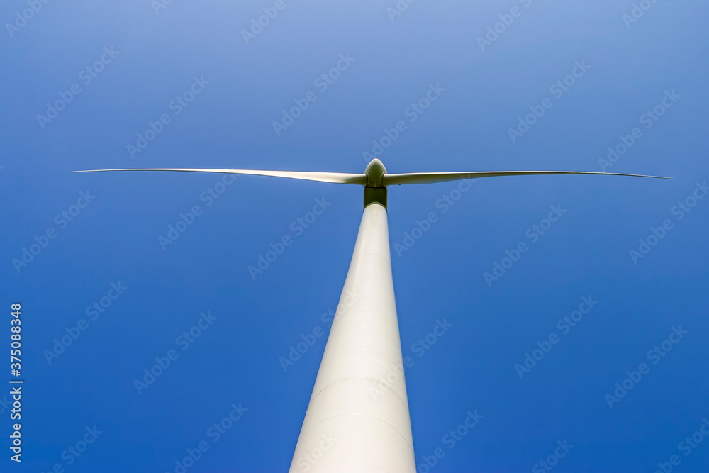 Wind turbine from below against a clear blue sky Wind turbine from below against a clear blue sky