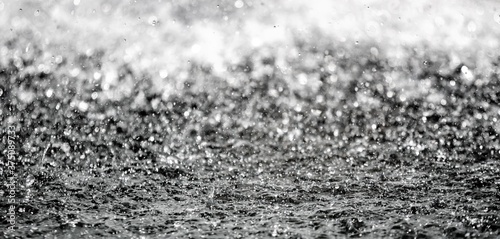 Large drops of water splashing background with blurred background
