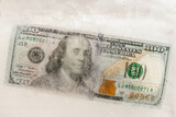 US dollars frozen under a layer of ice, the concept of the global financial crisis or the fall of the dollar in the world market