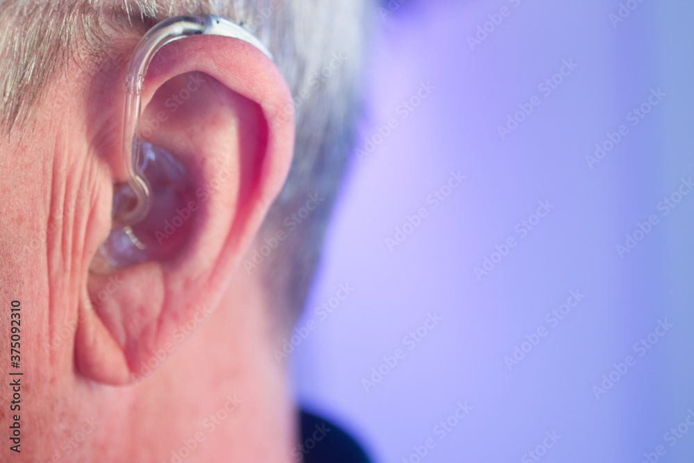 Man with hearing aid Man with hearing aid