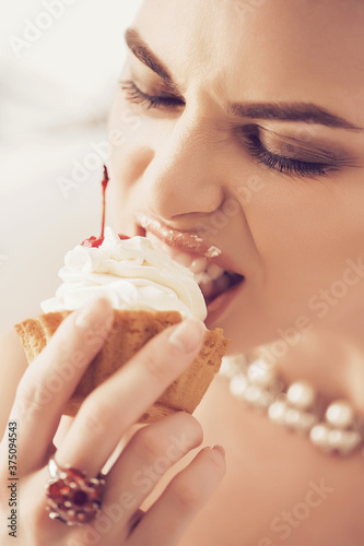 Woman eating cream from cake