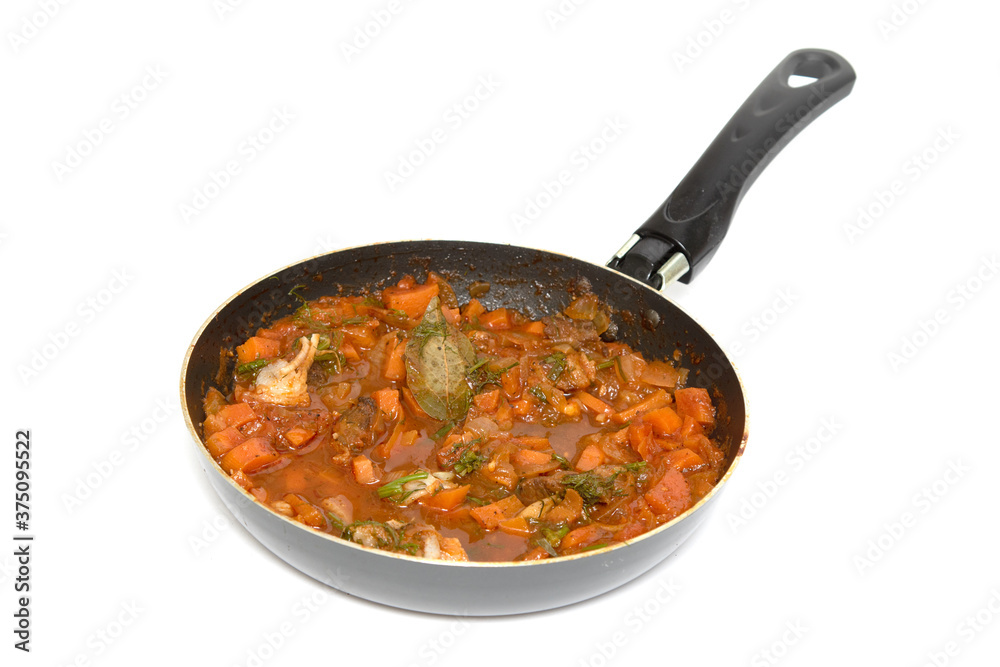 Frying pan with tomato frying isolated on a white background. Frying pan with tomato frying isolated on a white background.